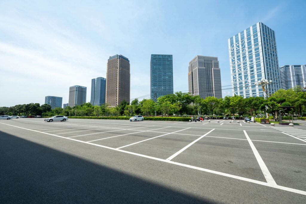 The empty parking lot in front of the city residential area