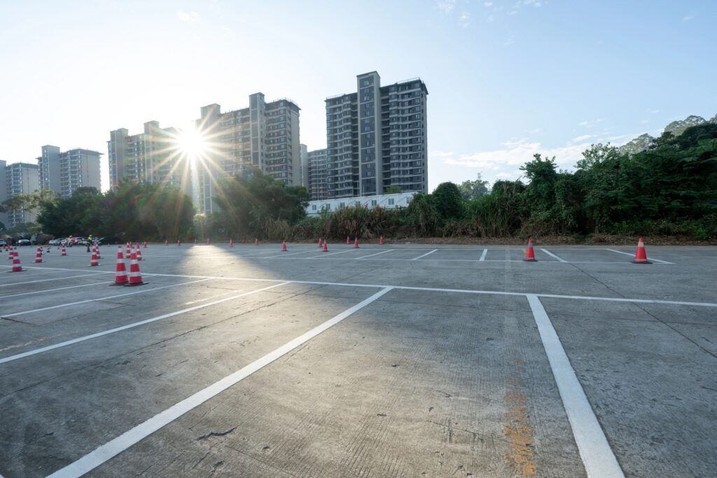 The empty parking lot in front of the city residential area