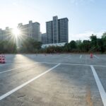 The empty parking lot in front of the city residential area